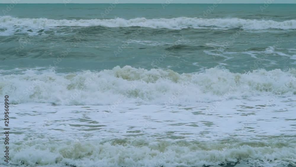 Stormy sea waves during bad weather cyclone hurricane Winds. Slow motion sea waves splash beach. Stormy sea waves during bad weather cyclone hurricane Winds. Slow motion sea waves splash beach.