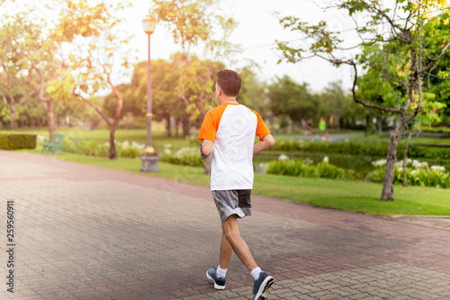 Unidentified middle aged man jogging in the park in morning. © bignai