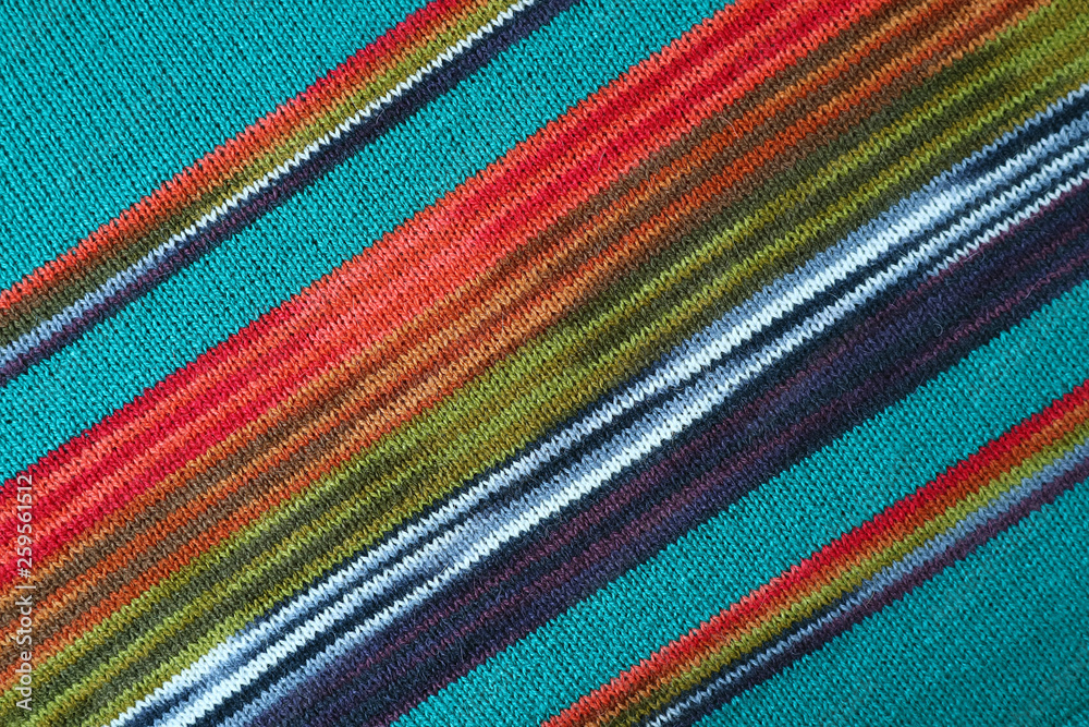 Diagonal Patterns and the Texture of Turquoise Blue with Red and Green Striped Alpaca Knitted Wool Fabric Diagonal Patterns and the Texture of Turquoise Blue with Red and Green Striped Alpaca Knitted Wool Fabric