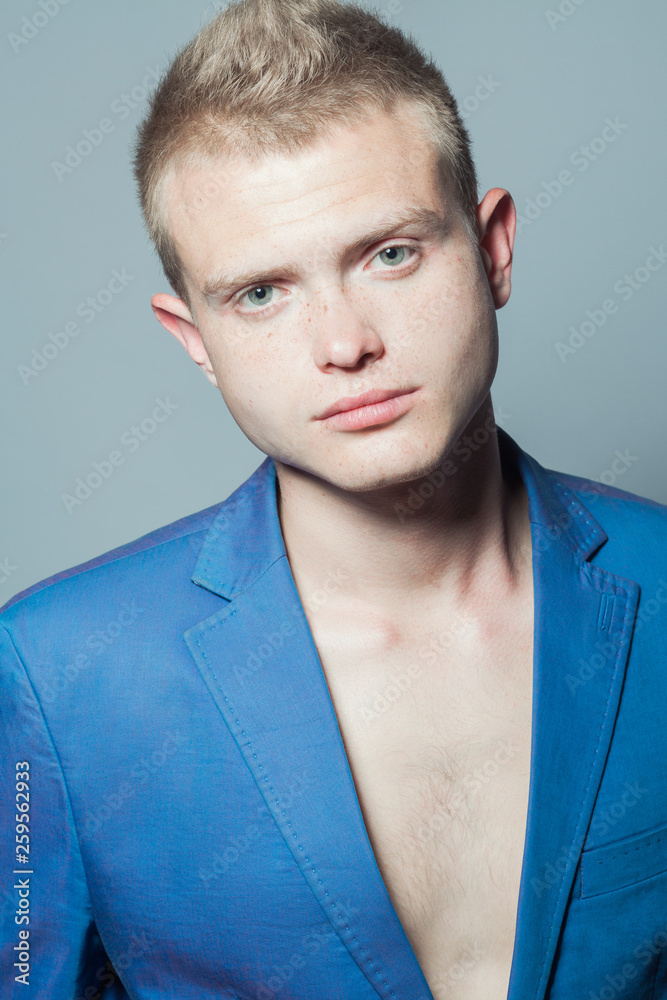 Male beauty concept. Portrait of young man with perfect haircut wearing  blue classic jacket. Hollywood star style. Blue-eyed boy with blond hair.  Studio shot Photos | Adobe Stock