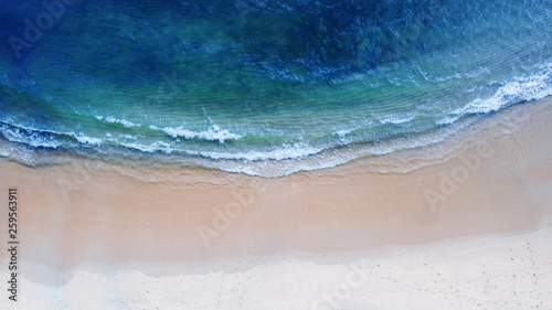 Aerial top view, Beach with shade emerald blue water and wave foam on tropical sea