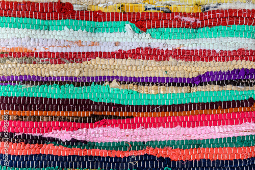 Background of manually woven textile materials of different colors, red, green, yellow, blue, green and pink pieces