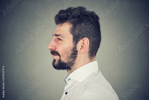 Fototapeta Naklejka Na Ścianę i Meble -  Side view portrait of a smiling bearded man