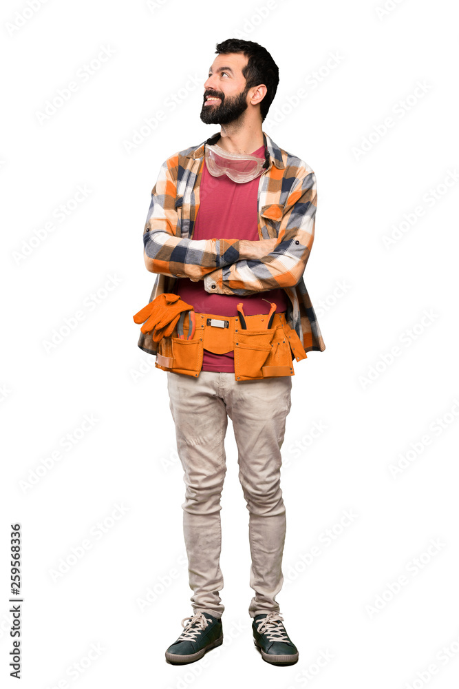 Craftsmen man looking up while smiling over isolated white background Craftsmen man looking up while smiling over isolated white background