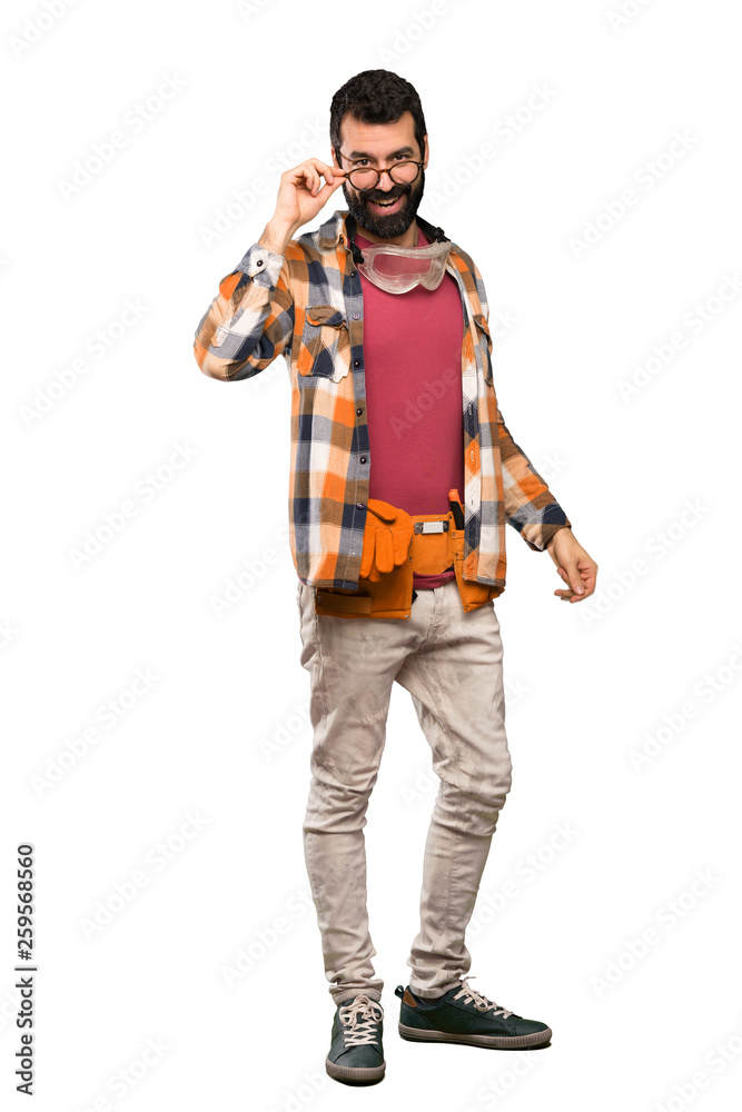 Craftsmen man with glasses and surprised over isolated white background Craftsmen man with glasses and surprised over isolated white background