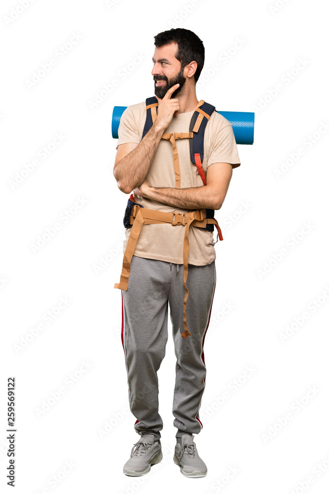 Hiker man looking to the side over isolated white background Hiker man looking to the side over isolated white background