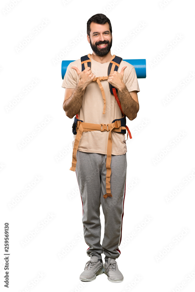 Hiker man with thumbs up gesture and smiling over isolated white background Hiker man with thumbs up gesture and smiling over isolated white background