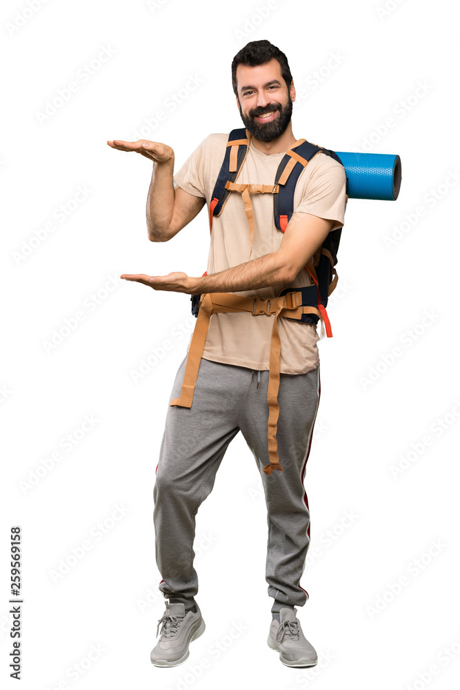 Hiker man holding copyspace to insert an ad over isolated white background Hiker man holding copyspace to insert an ad over isolated white background