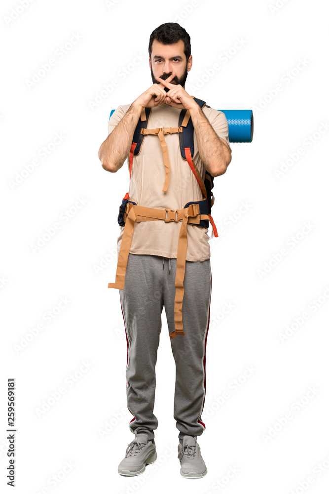 Hiker man showing a sign of silence gesture over isolated white background Hiker man showing a sign of silence gesture over isolated white background