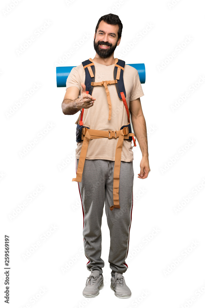 Hiker man shaking hands for closing a good deal over isolated white background Hiker man shaking hands for closing a good deal over isolated white background