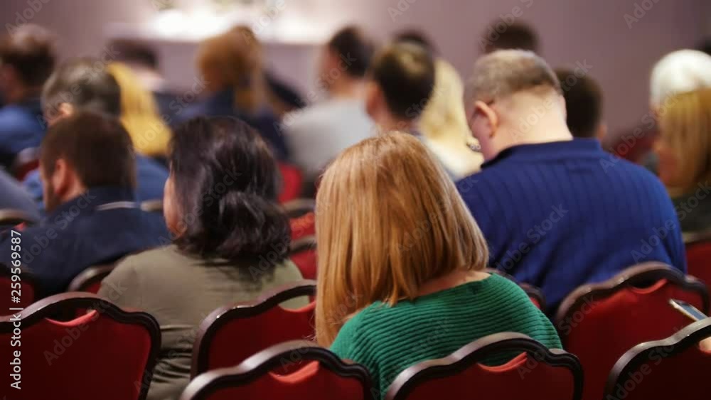 A business conference in the hall. People sitting on the chairs. A business conference in the hall. People sitting on the chairs.