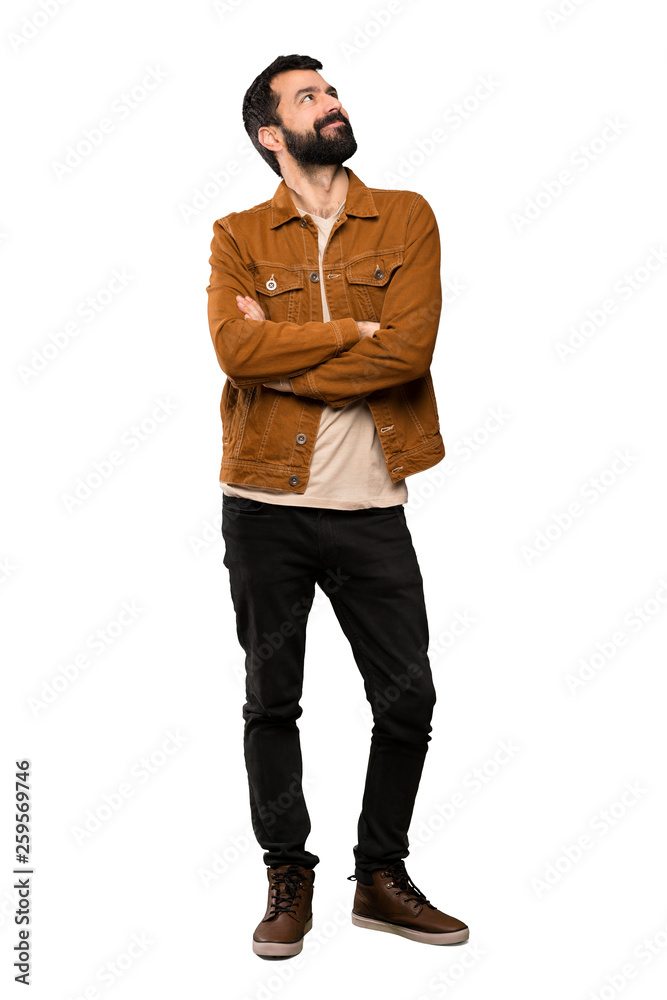 Handsome man with beard looking up while smiling over isolated white background Handsome man with beard looking up while smiling over isolated white background