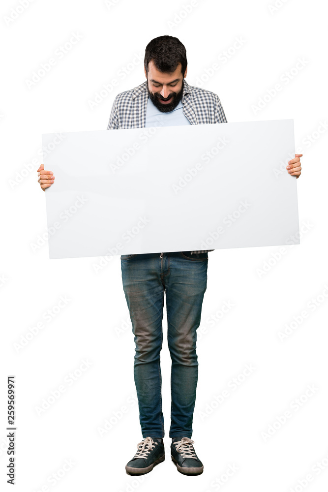 Handsome man with beard holding an empty placard Handsome man with beard holding an empty placard