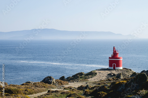 Old red lighthouse in Punta Robaleira, Pontevedra, Spain