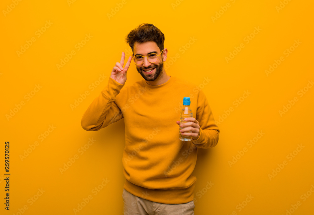 Young man fun and happy doing a gesture of victory