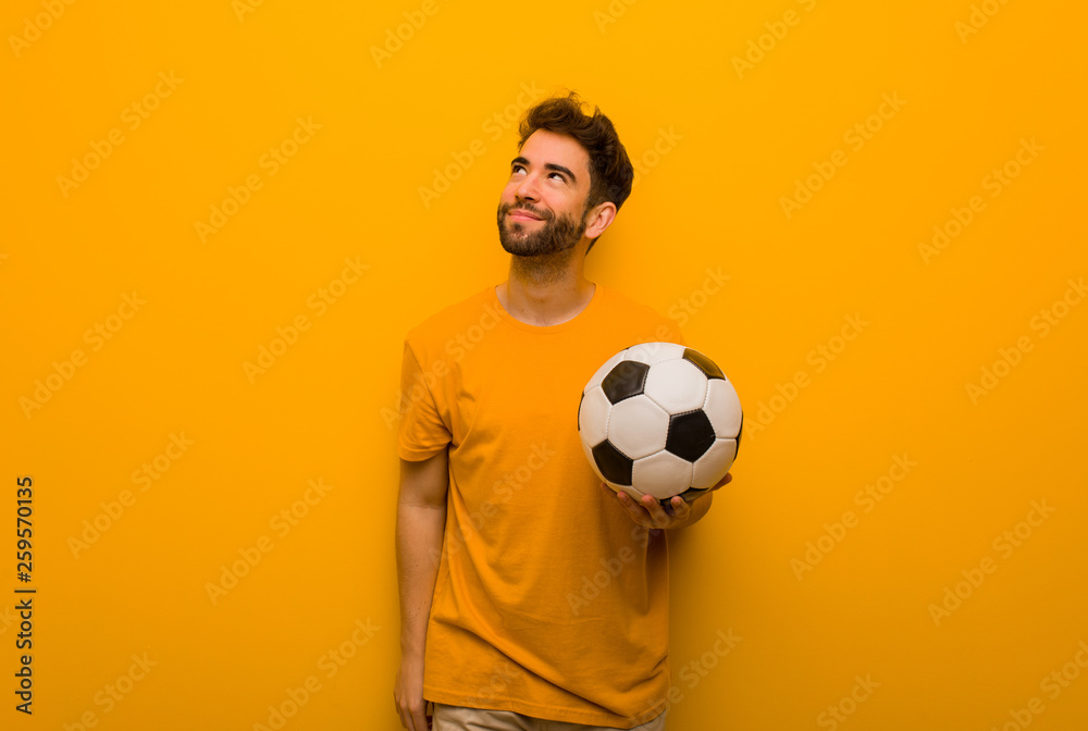 Young soccer player man dreaming of achieving goals and purposes Young soccer player man dreaming of achieving goals and purposes