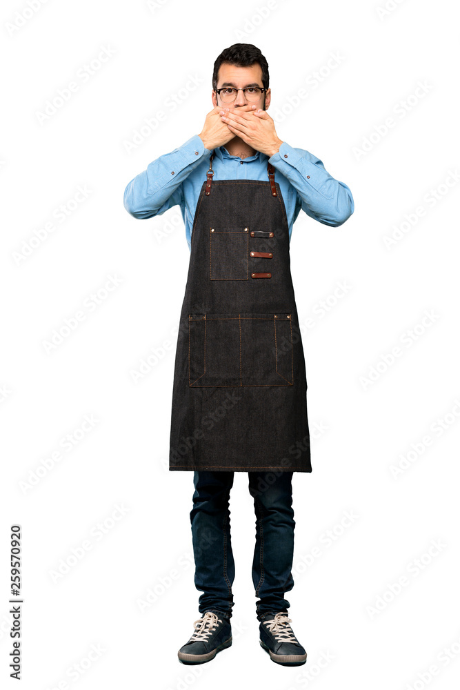 Full-length shot of Man with apron covering mouth with hands over isolated white background Full-length shot of Man with apron covering mouth with hands over isolated white background