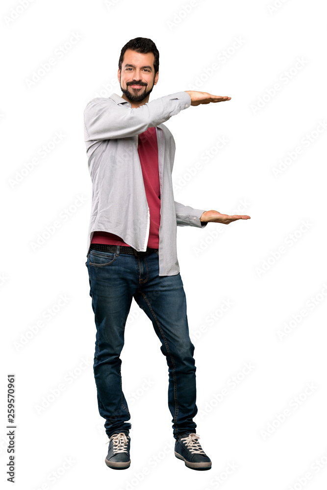 Full-length shot of Handsome man with beard holding copyspace to insert an ad over isolated white background Full-length shot of Handsome man with beard holding copyspace to insert an ad over isolated white background