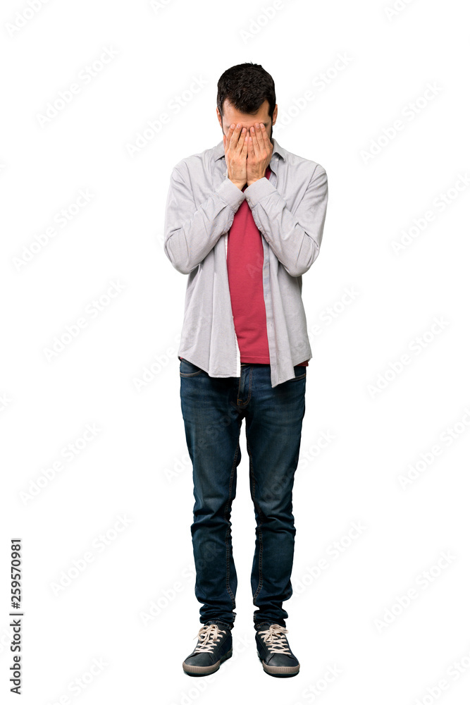 Full-length shot of Handsome man with beard with tired and sick expression over isolated white background Full-length shot of Handsome man with beard with tired and sick expression over isolated white background
