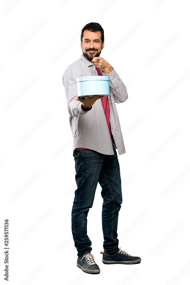Handsome man with beard holding a gift