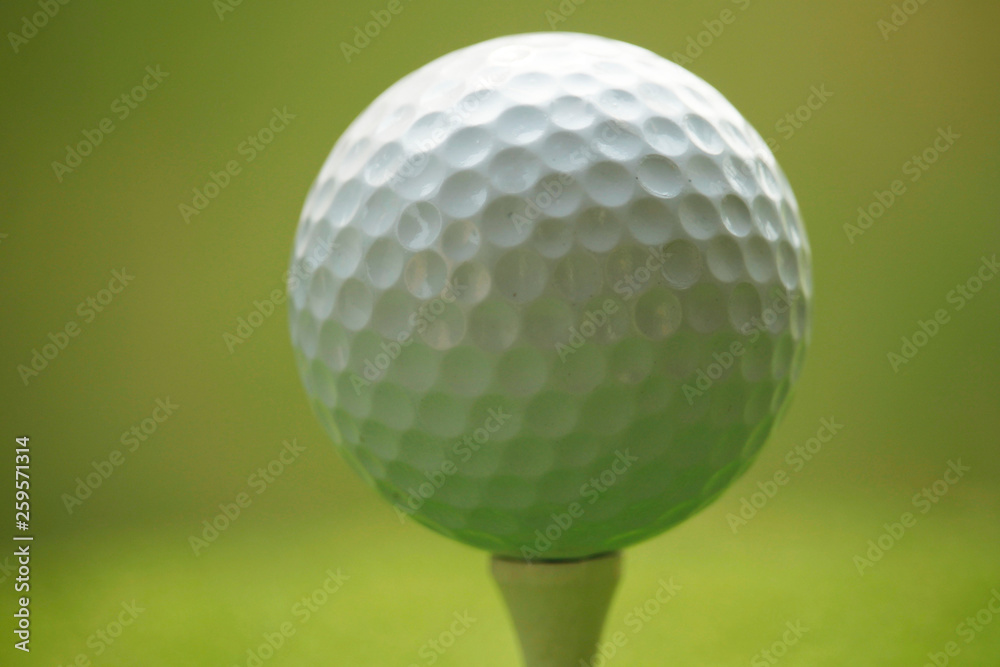 Golf ball on tee in beautiful golf course at sunset background. Golf ball on tee in beautiful golf course at sunset background.