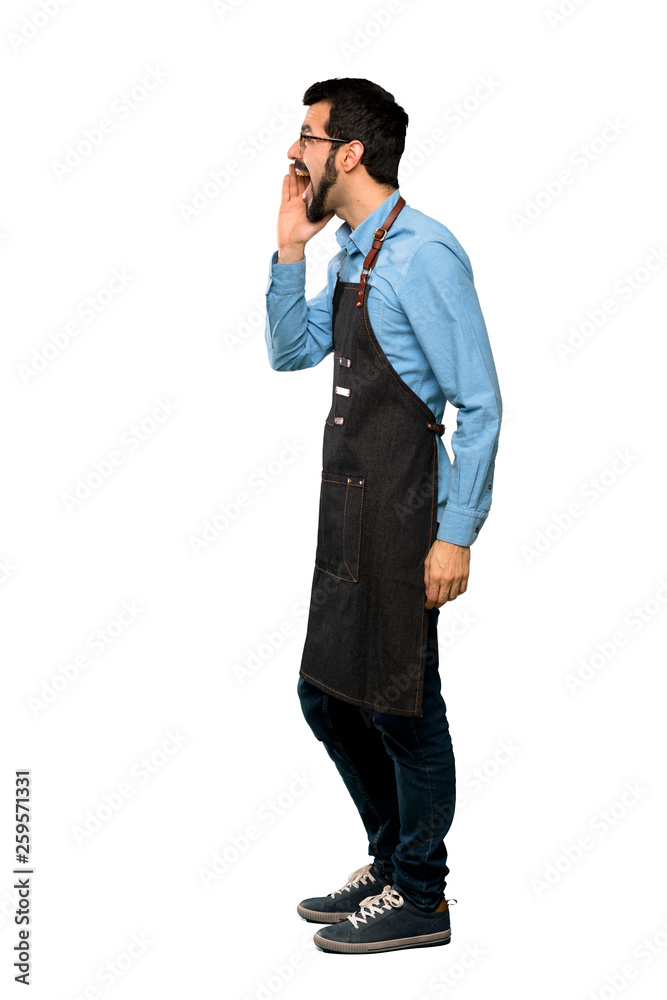 Full-length shot of Man with apron shouting with mouth wide open to the lateral over isolated white background Full-length shot of Man with apron shouting with mouth wide open to the lateral over isolated white background