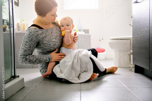 A mother and baby in a bath aving fun photo