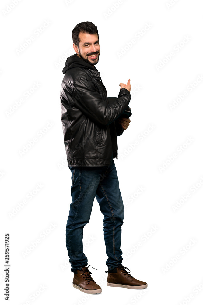 Naklejka premium Full-length shot of Biker man pointing back over isolated white background