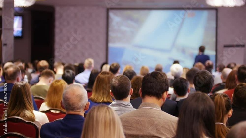 Wallpaper Mural A business conference in the hall. People sitting on the chairs and watching the presentation Torontodigital.ca