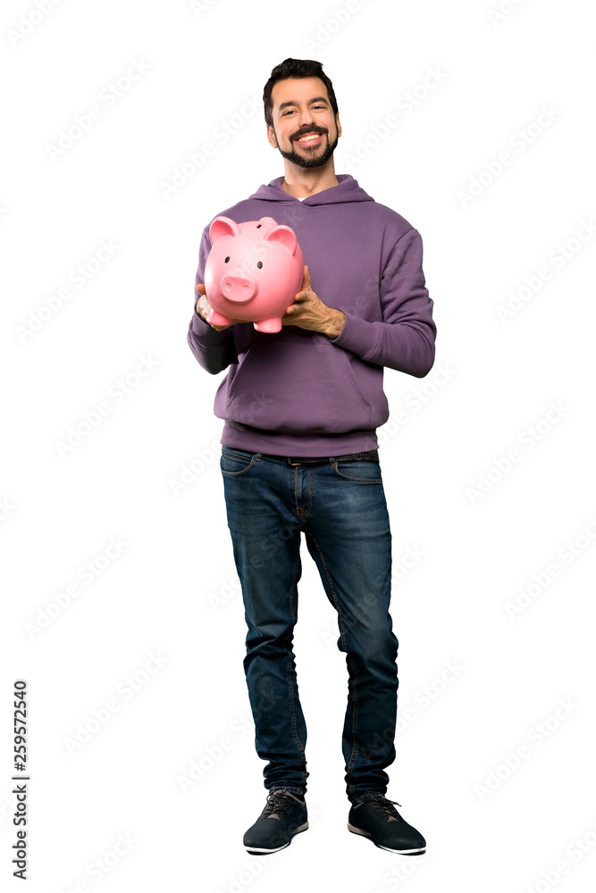 Handsome man with sweatshirt holding a piggybank Handsome man with sweatshirt holding a piggybank