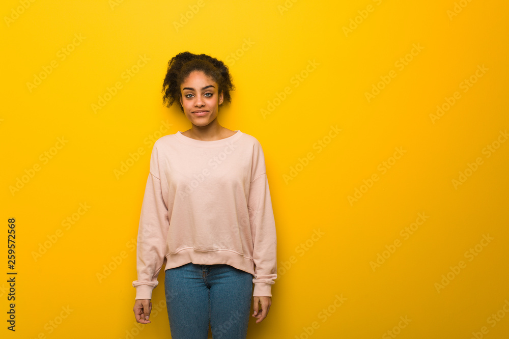Young pretty black woman over orange wall Young pretty black woman over orange wall