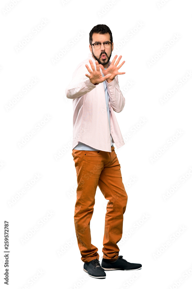 Full-length shot of Handsome man with beard nervous stretching hands to the front over isolated white background Full-length shot of Handsome man with beard nervous stretching hands to the front over isolated white background