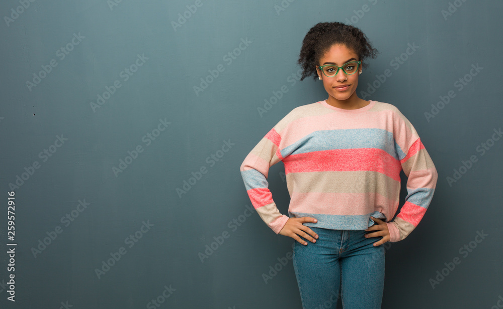 Young african american girl with blue eyes with hands on hips Young african american girl with blue eyes with hands on hips