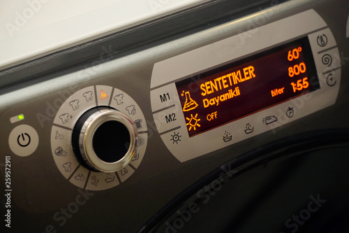 Electronic washing machine with scrolling dial and lcd screen close up view
