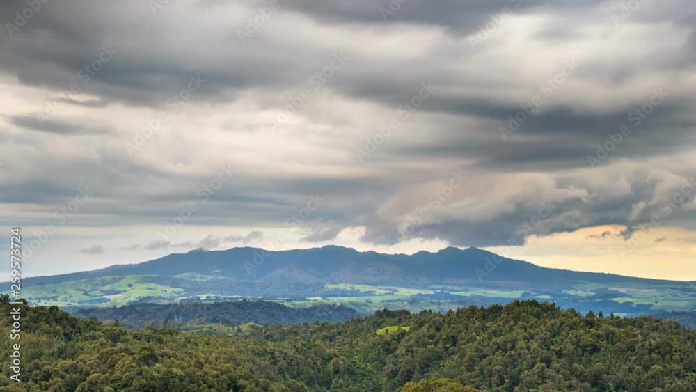 Dramatic storm clouds over Pirongia mountains forest park in New Zealand nature landscape Time lapse