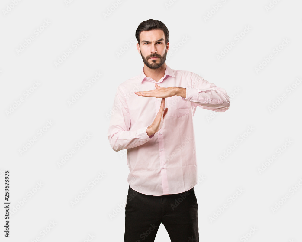 Young handsome man doing a timeout gesture Young handsome man doing a timeout gesture