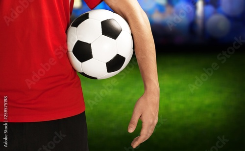 Young Male Soccer Player on blurred sport stadium background