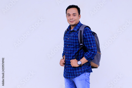 Happy young asian collage student with his ransel photo