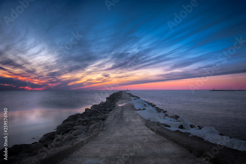 Fototapeta Naklejka Na Ścianę i Meble -  Road to the lighthouse. Sunset at the Baltic sea