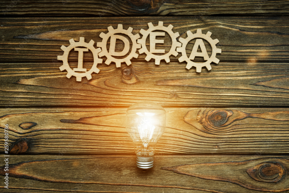 gears, idea, light bulb on wooden table background. creativity. gears, idea, light bulb on wooden table background. creativity.