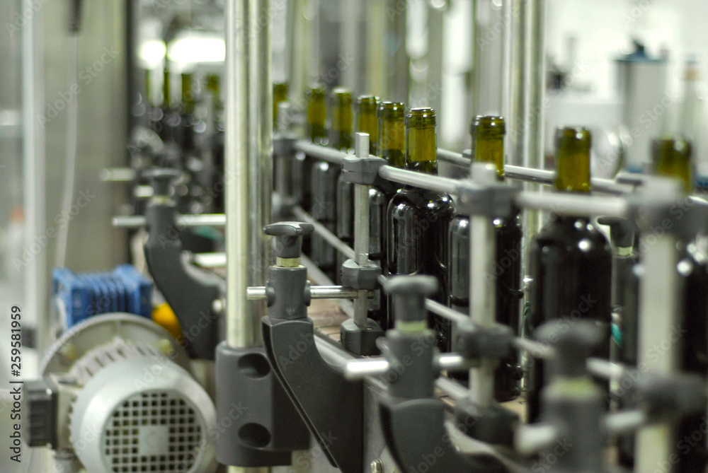 Red wine bottling and sealing conveyor line at winery factory Red wine bottling and sealing conveyor line at winery factory