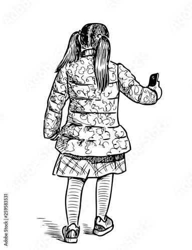A little girl with a cell phone goes on a stroll