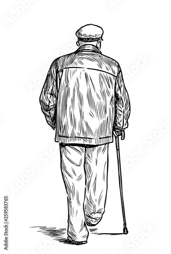 An old man with a cane goes down the street