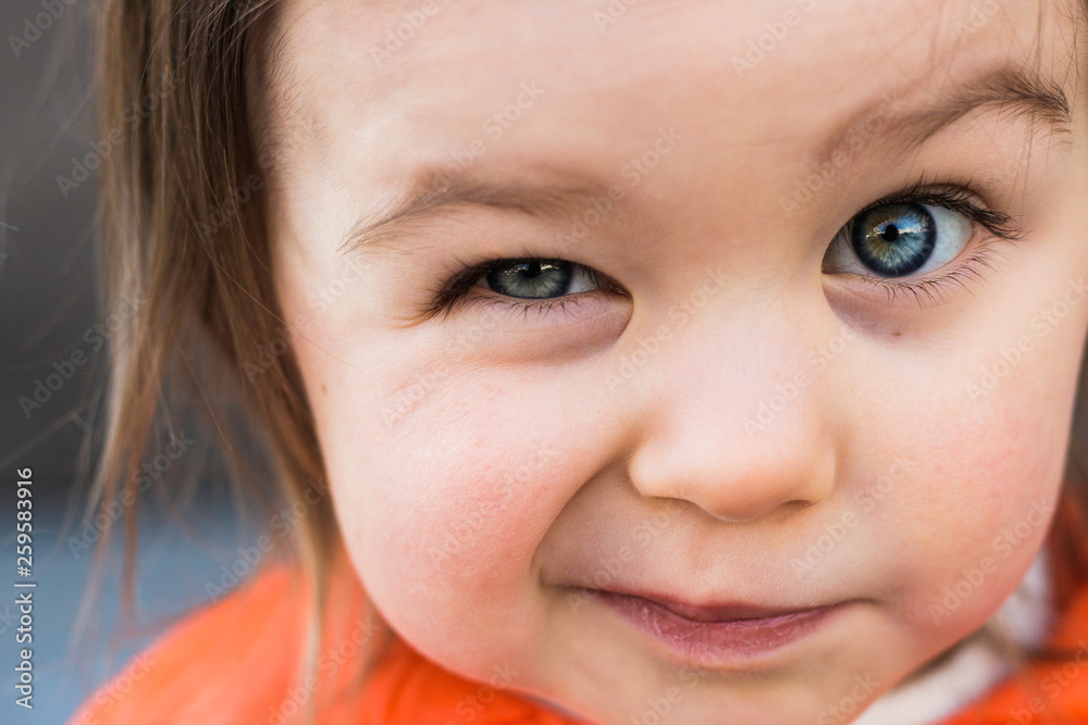 Funny Child Toddler Girl Winking Her Eye. Closeup Portrait, Beautiful Blue Baby Eyes Funny Child Toddler Girl Winking Her Eye. Closeup Portrait, Beautiful Blue Baby Eyes