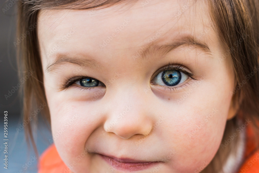 Funny Child Toddler Girl Winking Her Eye. Closeup Portrait, Beautiful Blue Baby Eyes Funny Child Toddler Girl Winking Her Eye. Closeup Portrait, Beautiful Blue Baby Eyes
