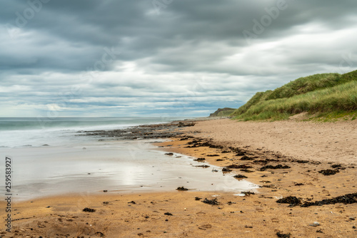 Fototapeta Naklejka Na Ścianę i Meble -  Dramatic sky over a beach, seen at Cocklawburn Beach near Berwick-upon-Tweed in Northumberland, England, UK
