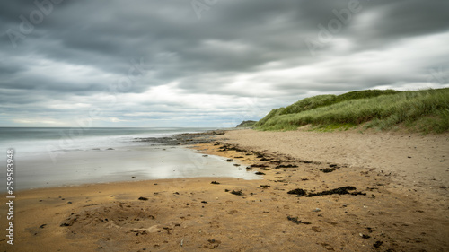 Dramatic sky over a beach, seen at Cocklawburn Beach near Berwick-upon-Tweed in Northumberland, England, UK photo