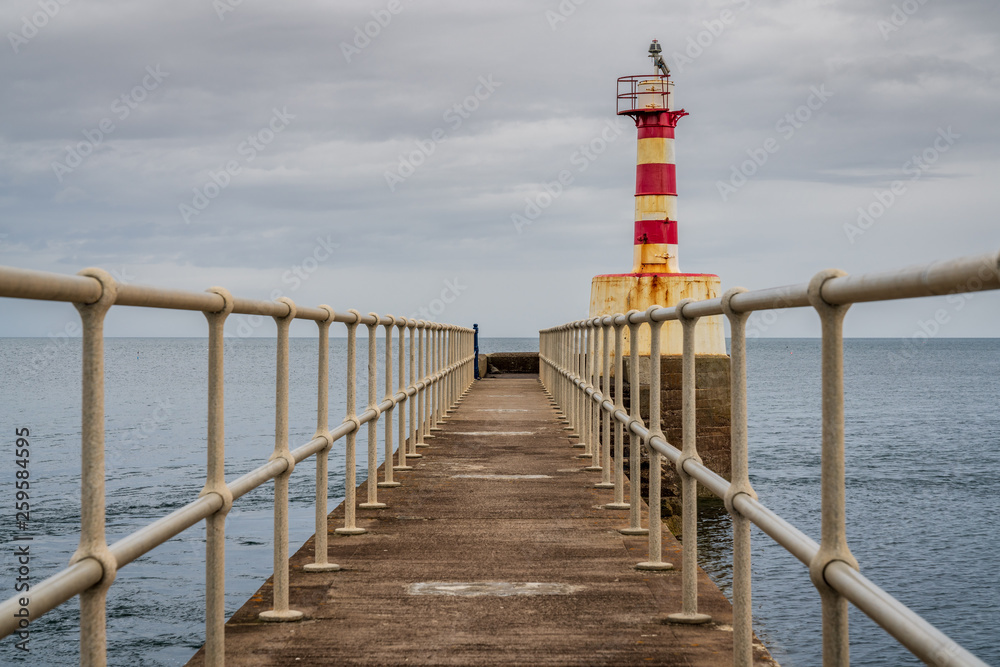 The Pier Lighthouse in Amble in Northumberland, England, UK, seen from the South Pier