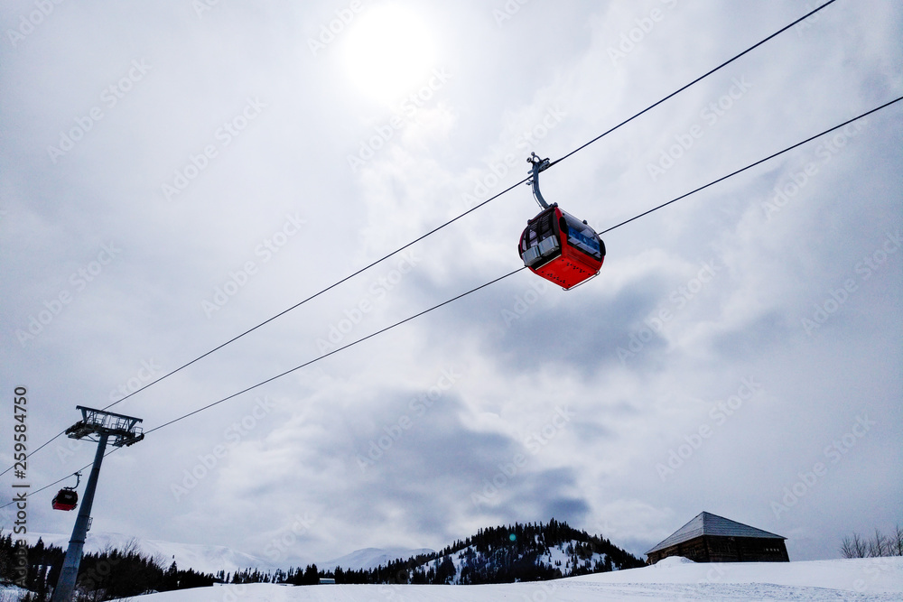 ski resort Goderdzi, Georgia. mountains are covered with snow. Red cable car above and mountains behind - Image ski resort Goderdzi, Georgia. mountains are covered with snow. Red cable car above and mountains behind - Image