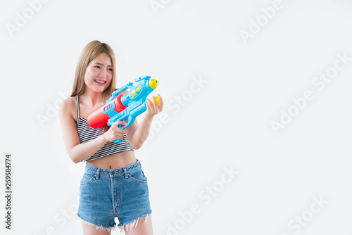 Asian sexy woman with gun water in hand on white background,Festival songkran day at thailand,The best of festival of thai,Land of smile